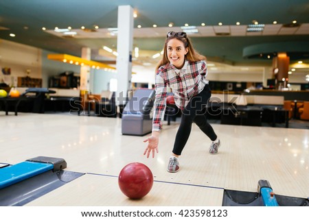 Beautiful woman enjoying  bowling