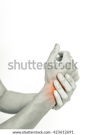 Young man holding his wrist in pain, isolated on white background, monochrome photo