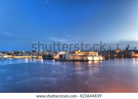 Early evening sunset HDR photo of the Valletta harbor with decorative light beams