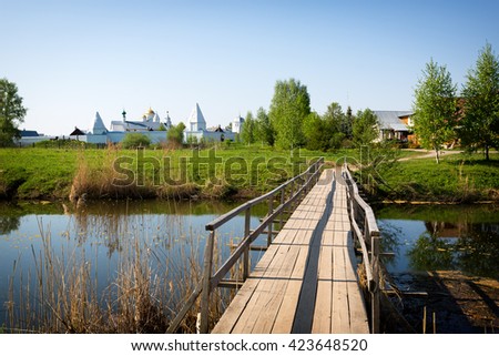 Old wooden bridge over river, rural landscape, Pokrovsky Monastery, Suzdal Vladimir region, Golden Ring of Russia