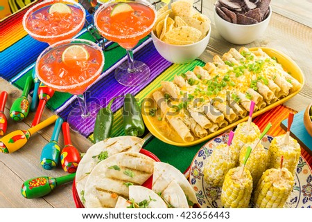 Fiesta party buffet table with traditional Mexican food.
