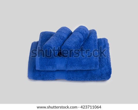 Blue Bathroom towel set Folded On Gray BAckground