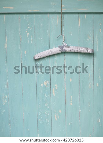 hanger on a blue wooden background, space for text, selective focus