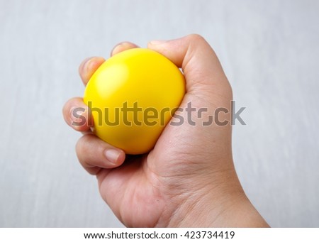 Hand with stressball Royalty-Free Stock Photo #423734419