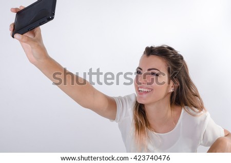 Young pretty girl making a selfie and smiling