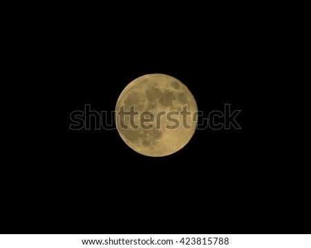 Full moon over dark black sky at night vintage sepia