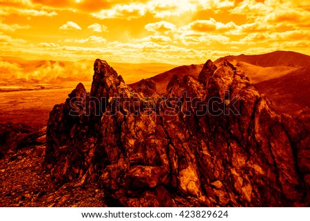 mountains illuminated by the sun. rock pick landscape . nature background. green colorful stones. steam above landshaft. 