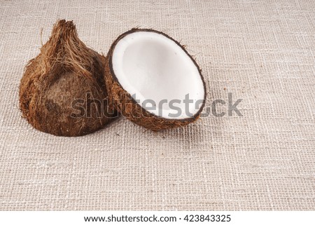 Coconuts on a light brown background. DOF and copy space
