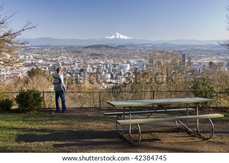 Male model overlooking city of Portland, Oregon.