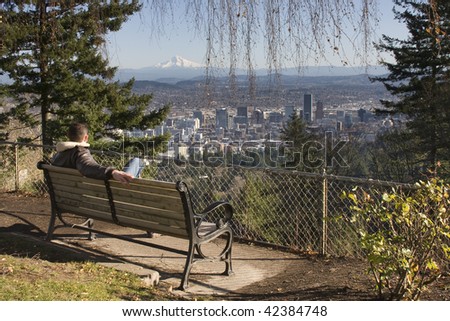 Male model overlooking city of Portland, Oregon.
