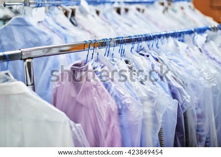 Weighs clean clothes on hangers and Packed in plastic bags Royalty-Free Stock Photo #423849454