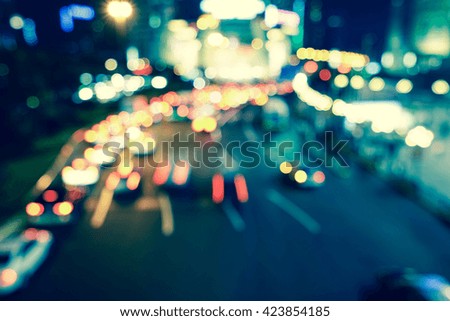 Artistic style - Vintage style, Defocused urban abstract texture bokeh city lights & traffic jams in the background with blurring lights.