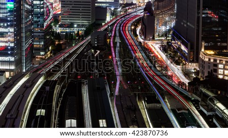 Bird view of Tokyo Station with train light trail at Night