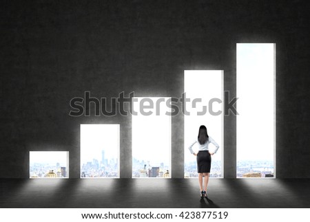 Success concept with businesswoman looking at wall with business chart and New York city view