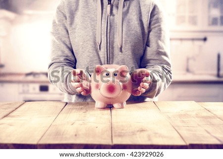 hipster photo of moneybox with hands and cash 