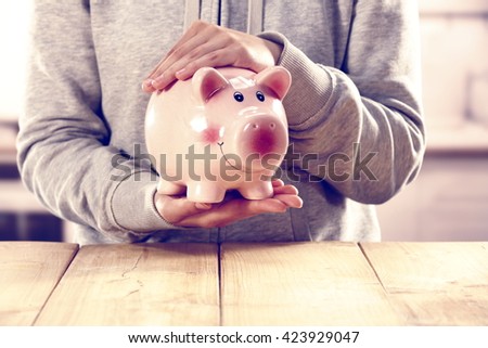 hipster photo of moneybox with closeup of hands 