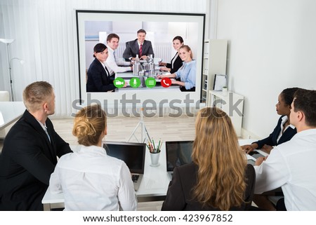 Group Of Businesspeople Together Videoconferencing At Workplace Royalty-Free Stock Photo #423967852