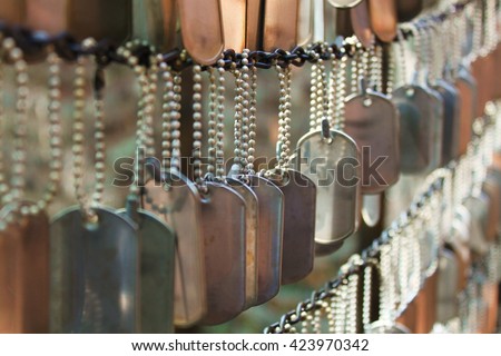 Dog Tags Honoring Fallen Soldiers Royalty-Free Stock Photo #423970342