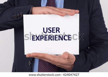 Man showing paper with USER EXPERIENCE text