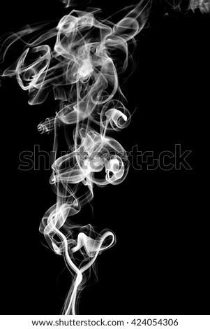 Black smoke on black background from the incense sticks