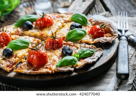 Freshly baked mini pizzas with tomatoes, cheese and basil