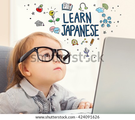 Learn Japanese concept with toddler girl using her laptop