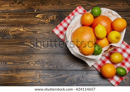 Basket with citrus fruit. Vitamin. Health. Freshness. Wood table. Top view.