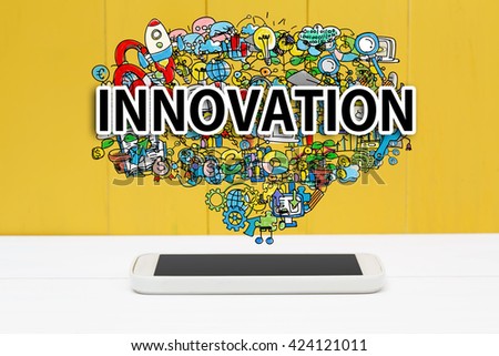 Innovation concept with smartphone on yellow wooden background