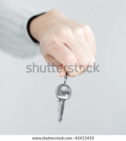 Woman`s hand holds a key