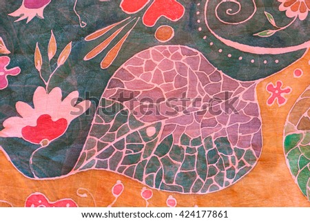 textile background - abstract hand painted floral ornament on black and brown silk batik