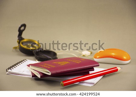 Gray background  travel with object around passport,Notebook,compass,
