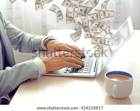 Financial concept. Make money on the Internet. Man working with laptop in office