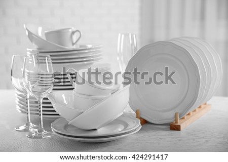 Set of new white dishes on wooden table, indoors Royalty-Free Stock Photo #424291417