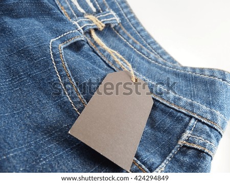 Blue jean pants, empty label with string 
