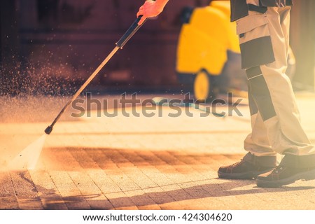 Residential Roadway Brick Cleaning Using High Pressured Water.  Royalty-Free Stock Photo #424304620