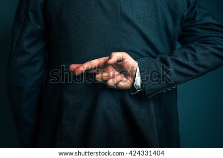 Dishonest businessman telling lies, lying male entrepreneur holding fingers crossed behind his back Royalty-Free Stock Photo #424331404