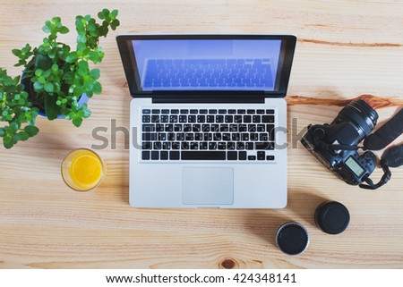 workplace of photographer, top view of gear, camera with lenses and laptop computer
