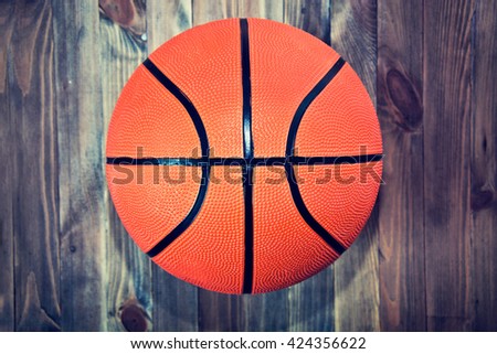 Basketball ball on wooden hardwood floor in the basketball court. Retro vintage picture. Sport concept.