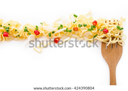 Instant noodle and wooden fork, spicy, onion, onion leaf with copyspace for web banner. Royalty-Free Stock Photo #424390804