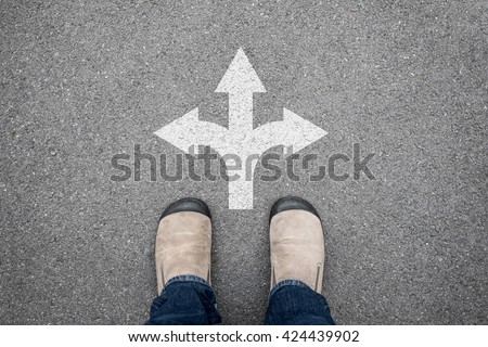 Brown shoes standing at the cross road making decision which way to go. Three ways to choose