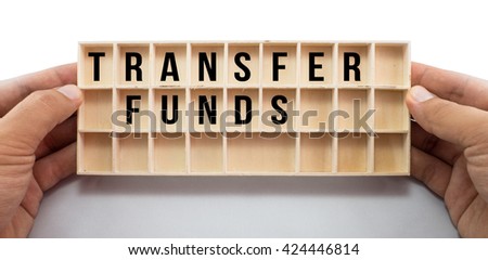 Mini wood rack box in boy's hands with Transfer Funds words. Isolated on white background