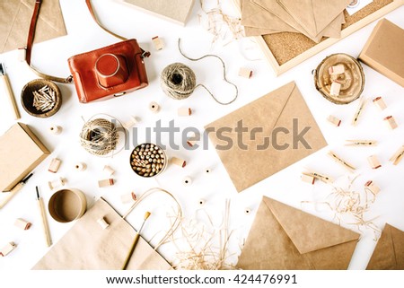 flay lay composition for bloggers, artists, magazines and social media. freelancer retro brown style workspace with vintage photo camera, craft envelope, pencils, tools and twine on white background.