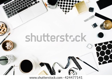 flay lay composition for bloggers, artists, magazines and social media. freelancer black style workspace with laptop, black coffee, sketchbook, napkins, ribbons, paintbrushes on white background.