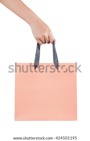 A female(woman) hand hold a pink shopping bag(paper bag) and gray strings at the studio