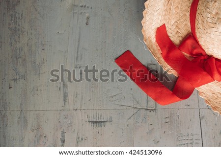 closeup of the straw hat with red ribbon