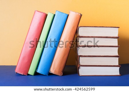 Stack of colorful books on table. Education background. Back to school. Copy space for text