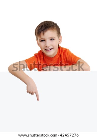 Cute smiling little boy above is the blank white banner and points on it. Portrait over white background