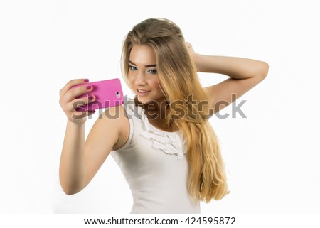 Young beautiful lady taking a selfie self portrait of herself smiling at he camera.Pretty hipster girl taking selfie. Close up portrait of a attractive woman holding a smartphone digital camera.