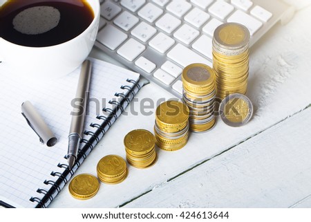 Euro coins with office things on wooden desk
