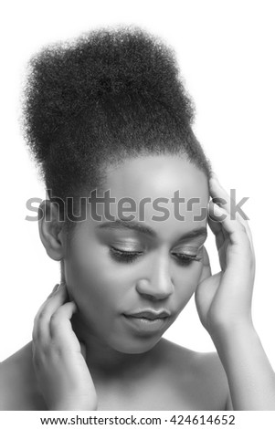 Beauty portrait of African woman with perfect skin looking down. Isolated on white background. Black and white